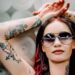 a woman with color and black and grey tattoos