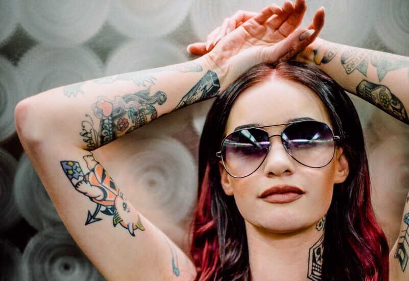 a woman with color and black and grey tattoos