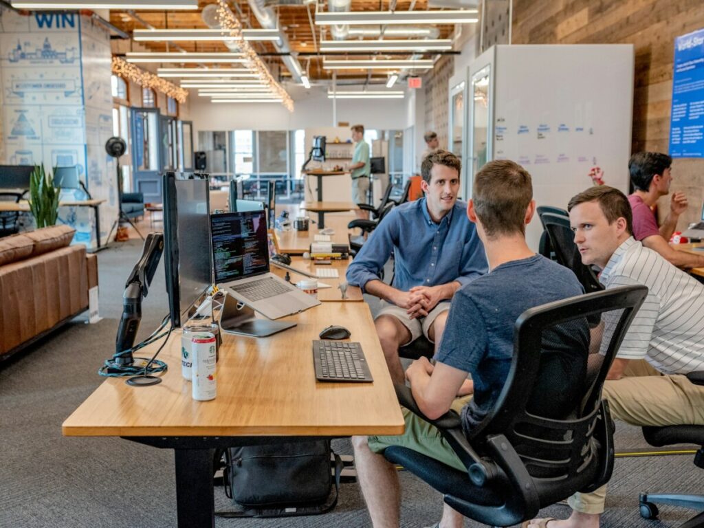 three person talking in the office